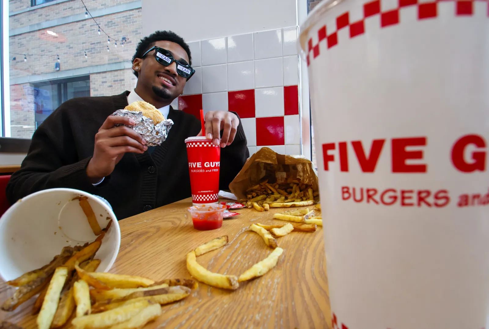 Student couriers preparing Five Guys delivery
